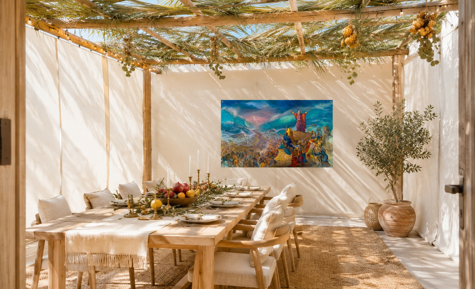 Colorful Jerusalem landscape print in teal, orange, and gold on the focal wall of a modern sukkah dining space.