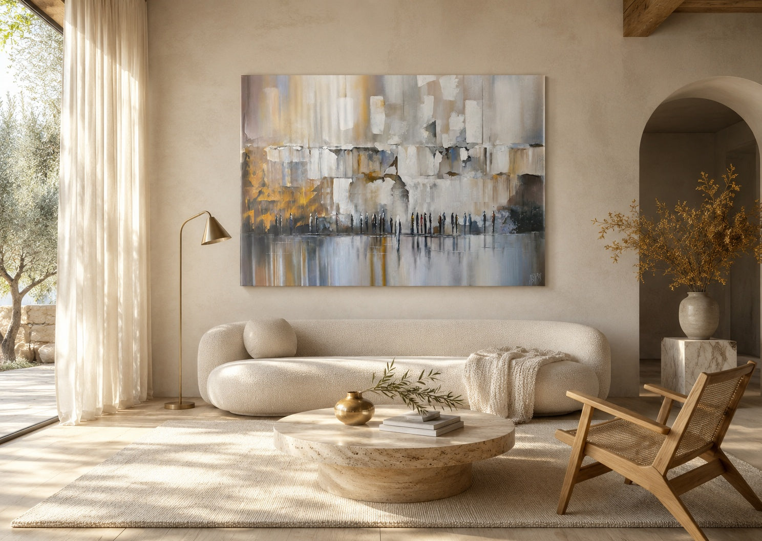 Large abstract Western Wall painting in white, gray, and gold above a curved cream sofa in a sunlit neutral living room