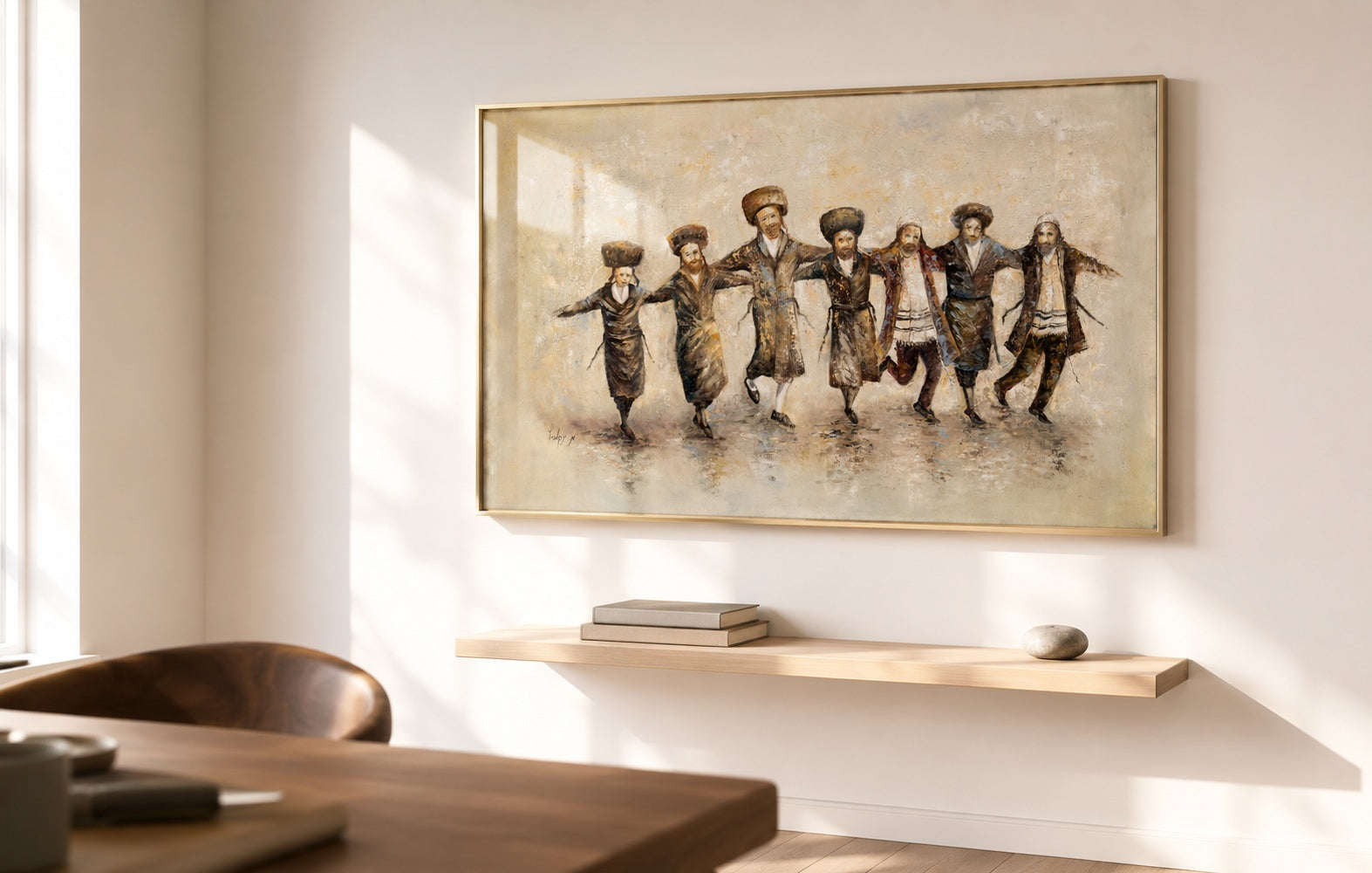 Framed sepia painting of seven dancing Hasidic men in black traditional dress above a floating wood shelf in a sunlit minimalist dining room.