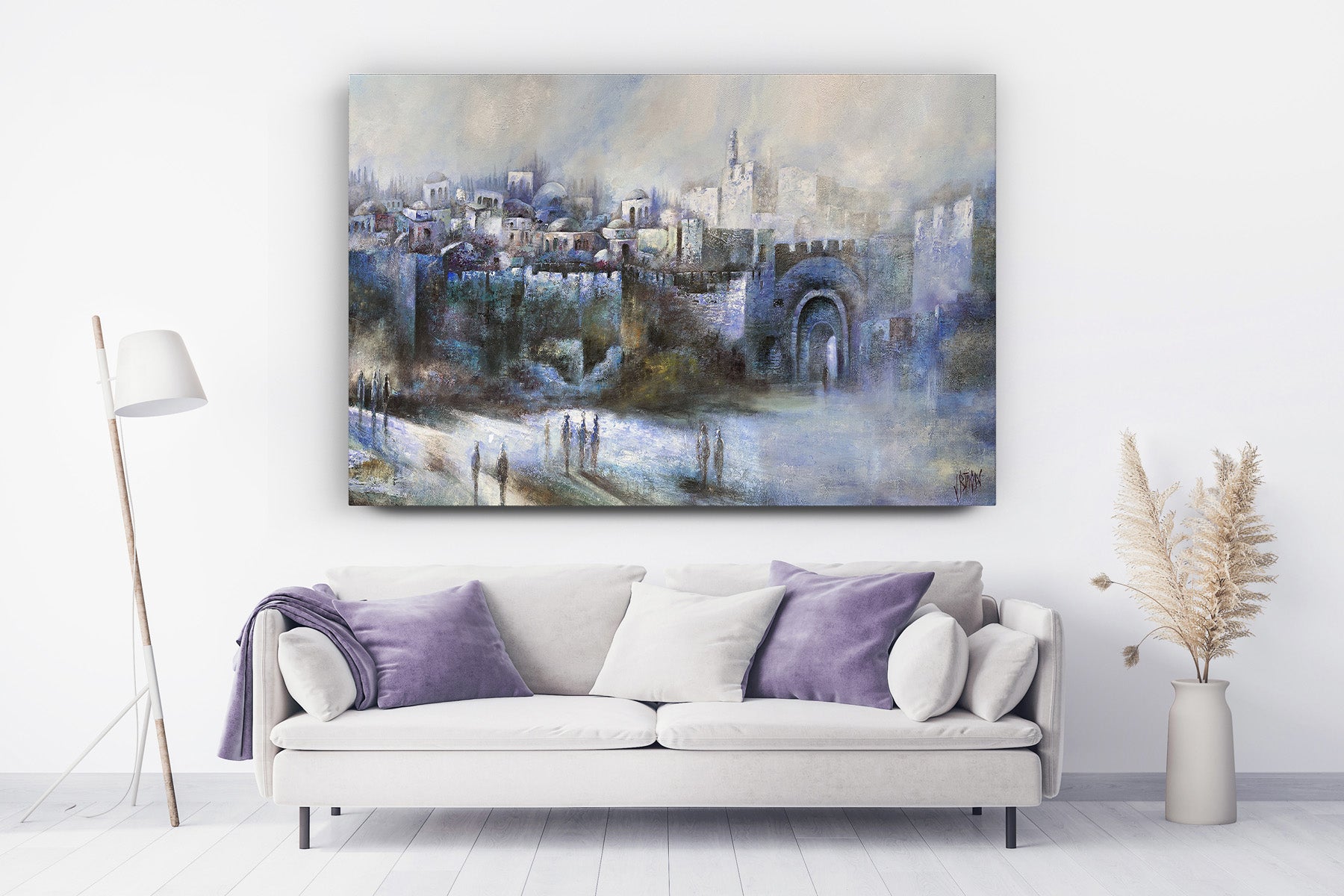 Har Hamor - Jerusalem Landscape by Yossi Biton, a captivating painting depicting a serene cityscape, elegantly displayed above a white couch with purple pillows.