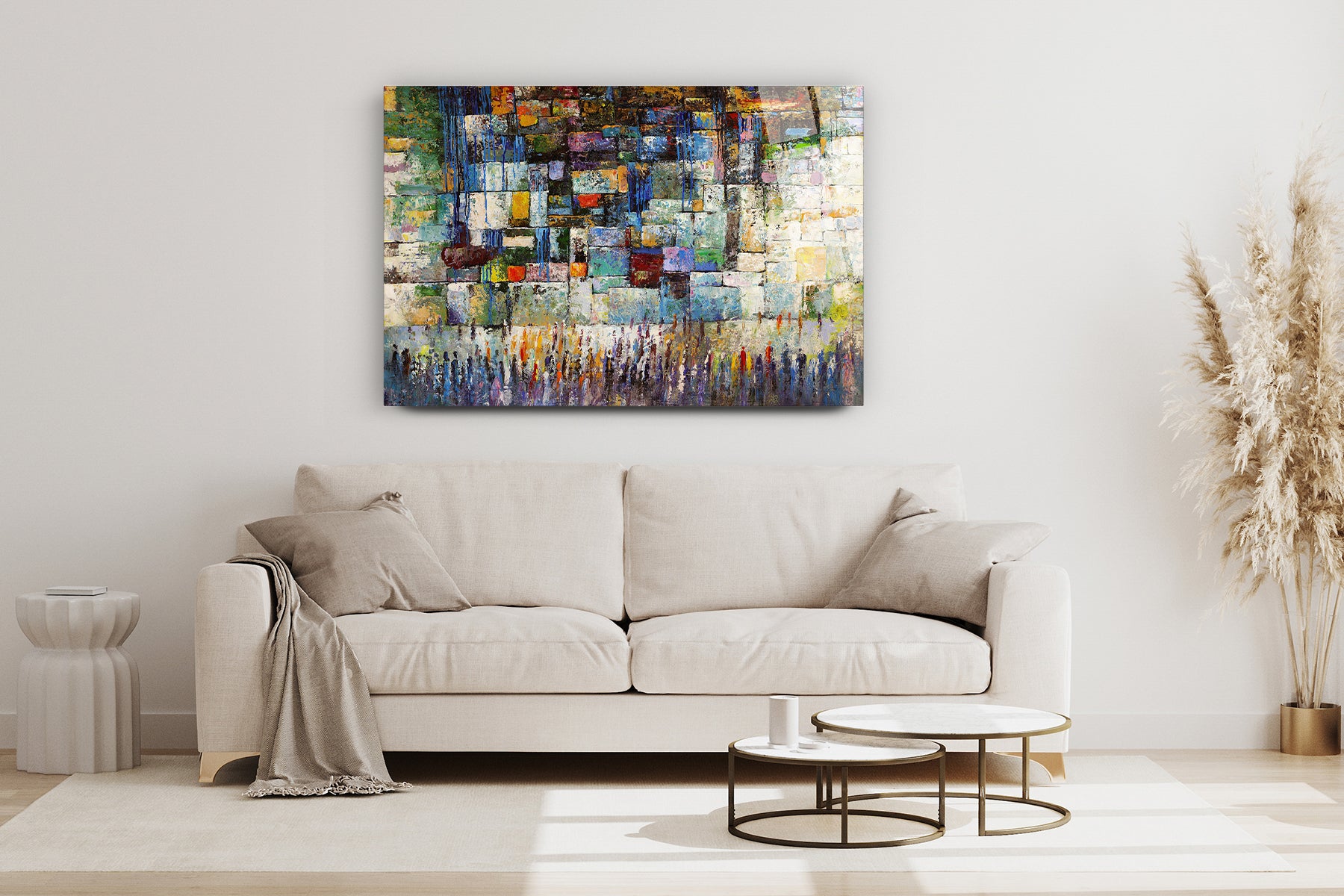The Western Wall - Colorful Abstract by Yossi Bitton displayed above a white couch, enhancing the living room with vibrant Jewish art.