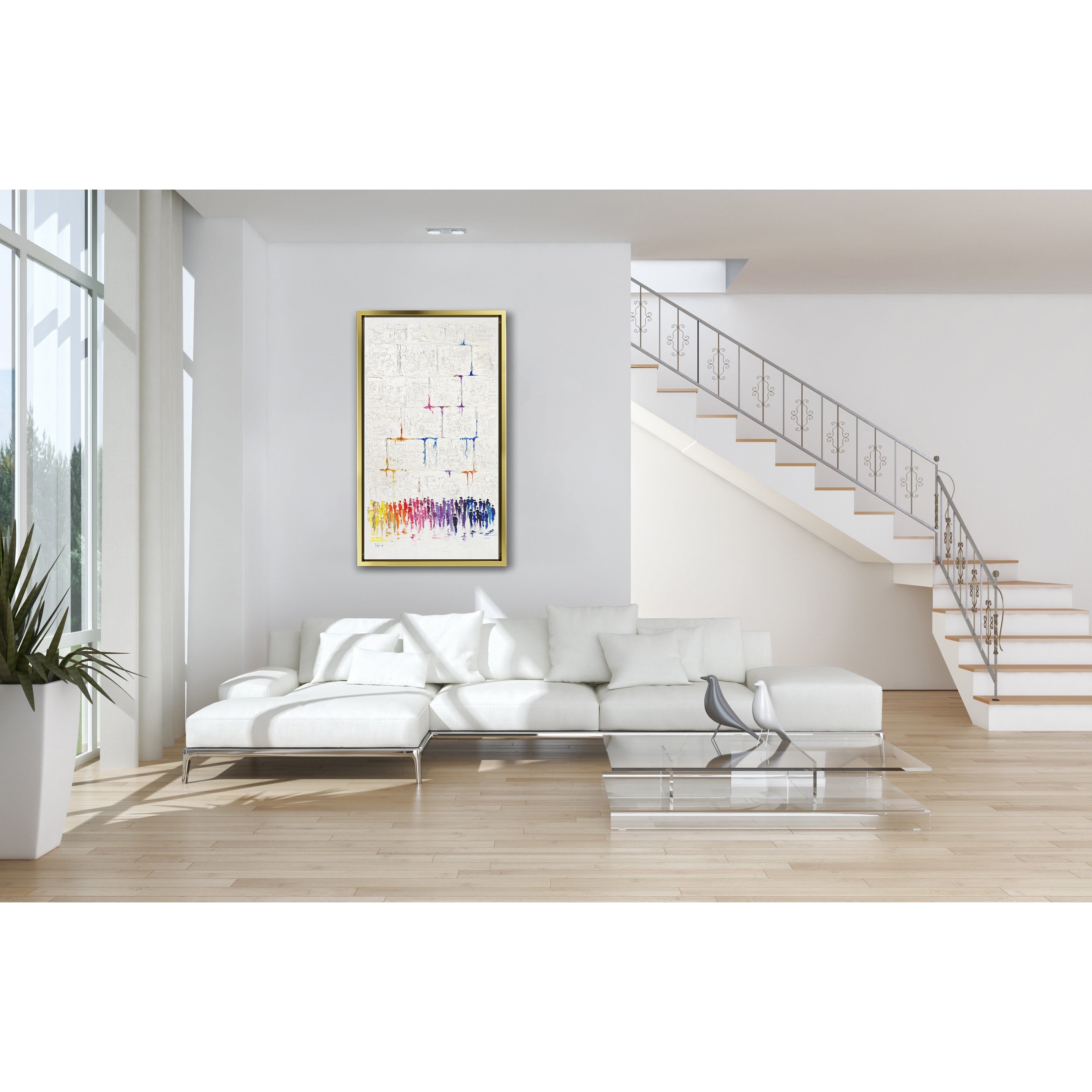 47x28 Abstract Western Wall Art featuring vibrant figures in prayer, set in a modern Jewish decor setting with a white couch and a gold-framed painting nearby.