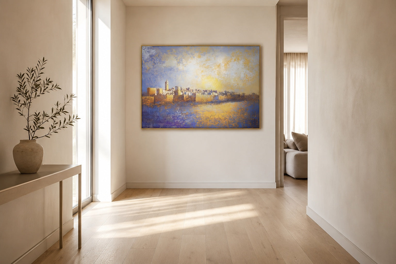 Impressionist Jerusalem skyline painting in gold and blue hanging in a bright minimalist hallway with olive branch vase