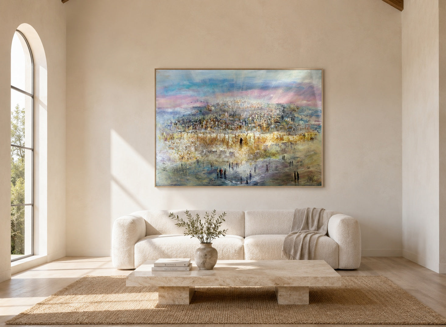 Abstract Jerusalem cityscape painting in pink, gold, and ivory tones, brass floater frame, above an ivory sofa in a bright minimalist living room.
